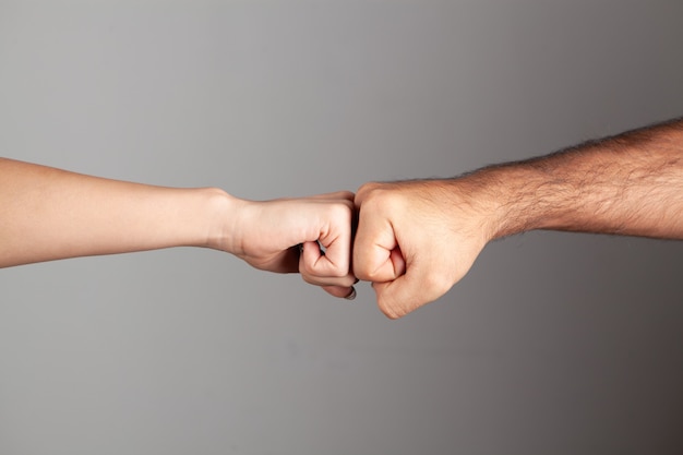 A man and a woman touching their fists