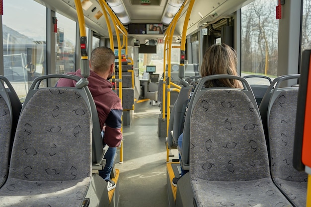 Man and woman travel in to the bus with a mask