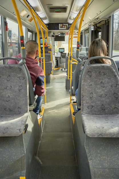 Man and woman travel in to the bus with a mask