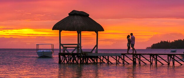 Man and Woman on a tropical beach in Mauritius a couple on honeymoon vacation in Mauritius