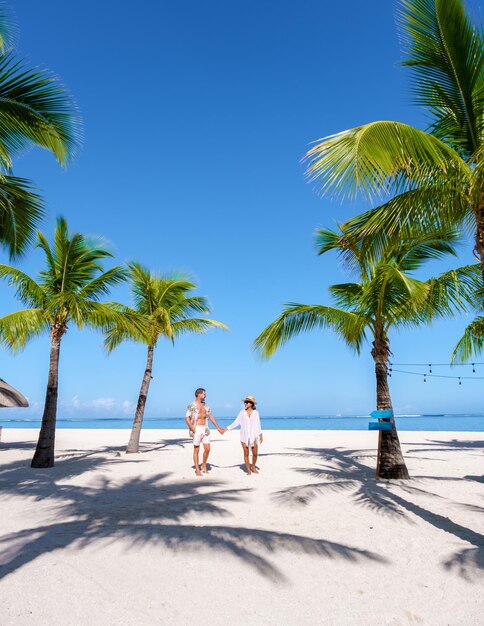 Man and woman on a tropical beach in mauritius a couple on honeymoon vacation in mauritius