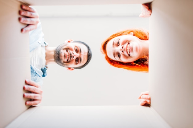 Man and woman, view from inside the cardboard box