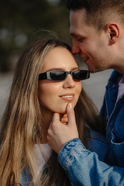 A man and a woman wearing sunglasses with the word love on them