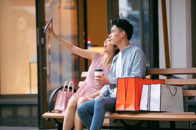 Man and woman with colorful shopping bags