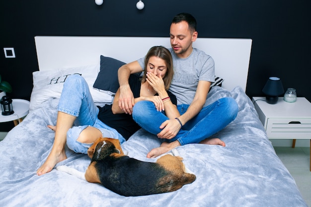 Man and Woman with dog on bed