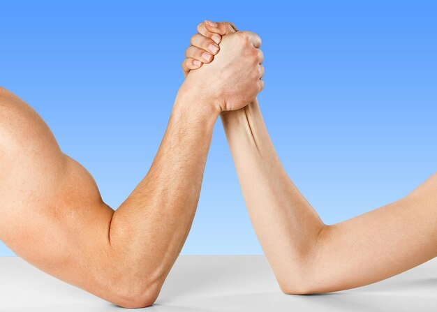 A man and woman with hands clasped arm wrestling, isolated on white