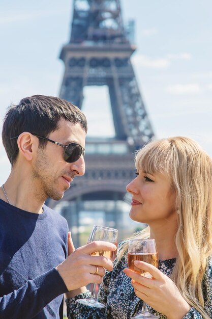 Man and woman with wine near the eiffel tower Selective focus