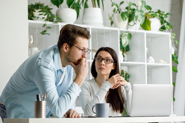 A man and a woman work in an office