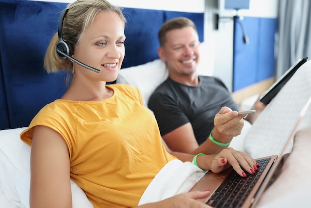 Man and woman work remotely in bed from home telework and freelance operator concept