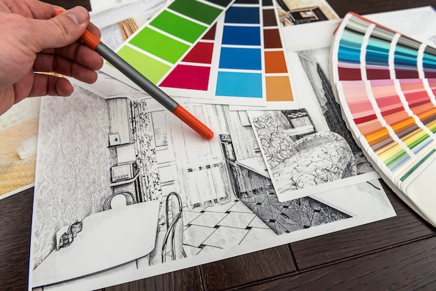 Man work with Color palette and house apartament sketch for creative design home. Architect renovation plan