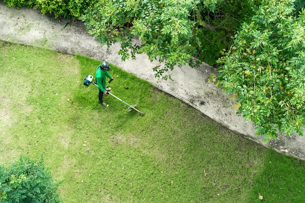 Man worker cutting  grass with lawn mower