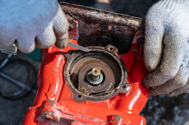 Man worker repairing engine with his hands close up