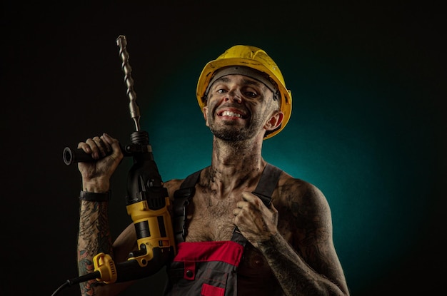 man in a worker s clothes and a helmet dirty in soot with a naked body grimaces at the camera miner