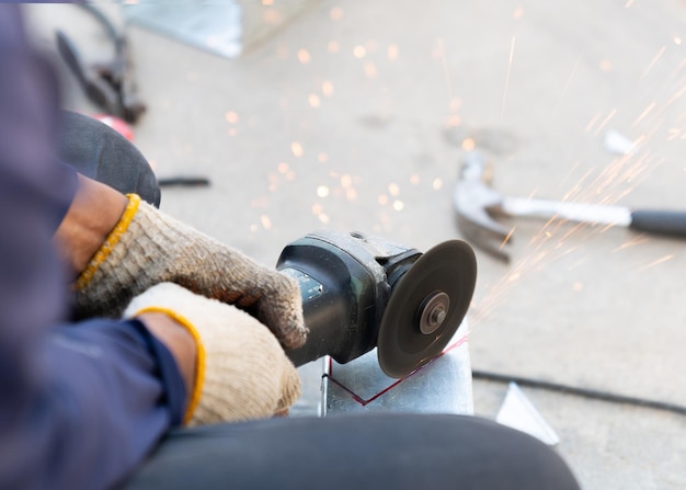 Photo man worker use handle fiber cutting to cut metal rail electric line in factory