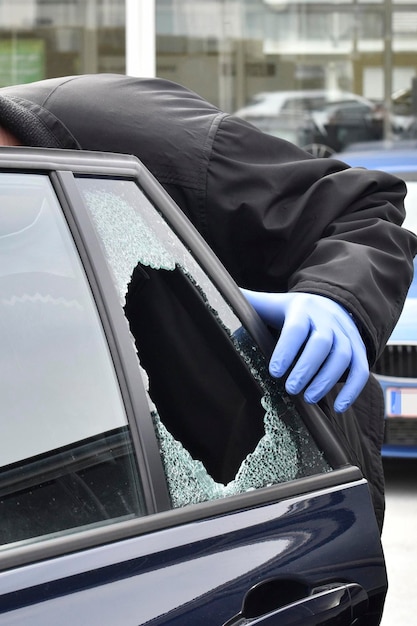 Man working on car window