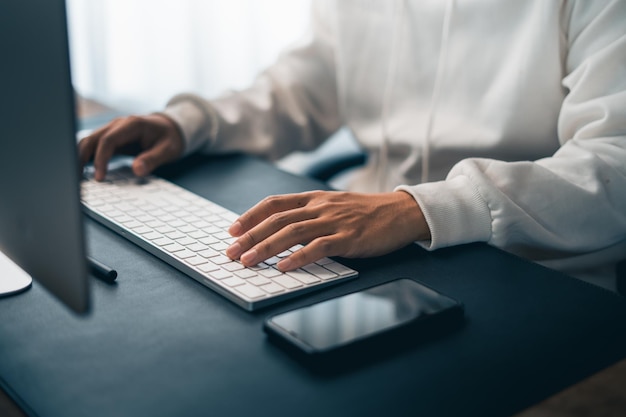 Man working on computer desk at home office