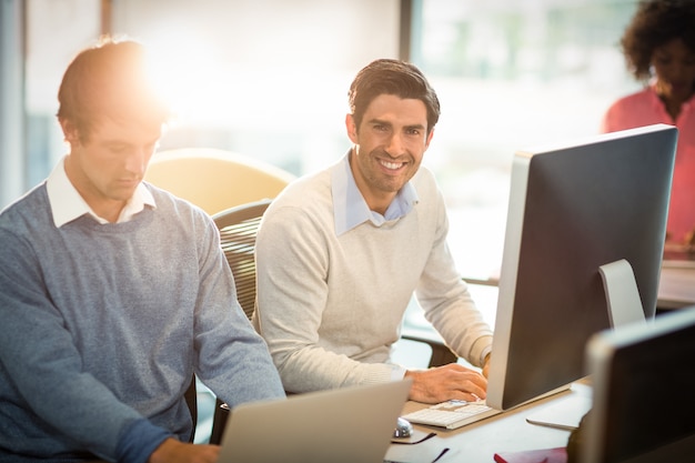 Man working on computer with coworker