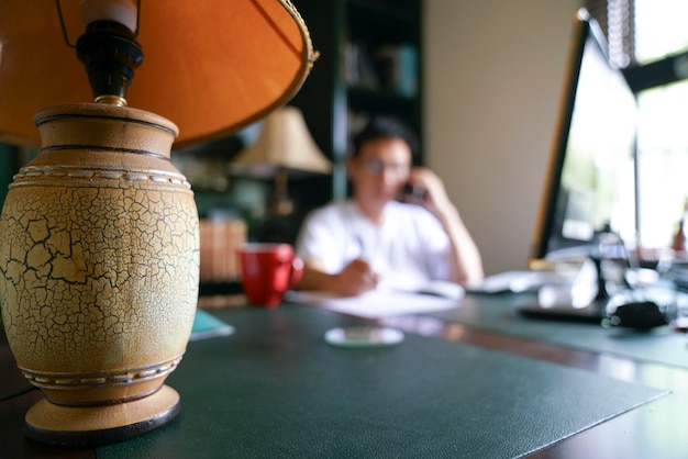 Man working from home Focus on table lamp