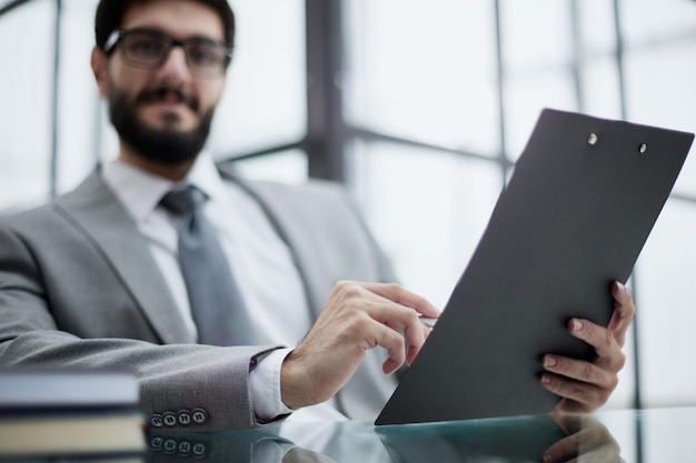 Man working from home office doing notes sitting at desk