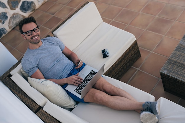 Man working from home at the yard on his computer