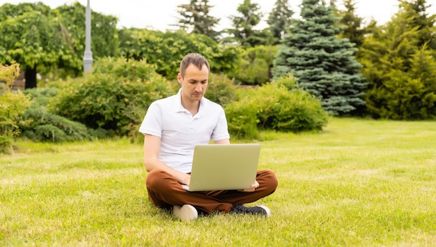 Man working on his laptop in the park.