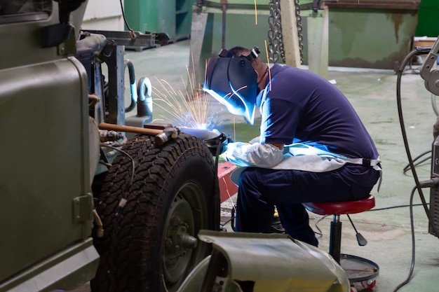 A man working on a jeep in a workshop