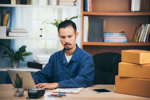 The man working laptop computer from home with postal boxes