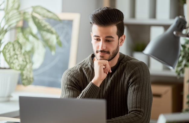 Man working on a laptop at home.