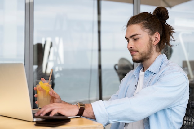 Man working on laptop side view