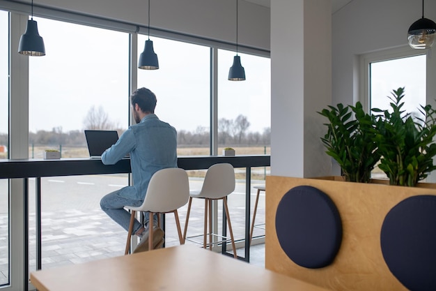 Photo man working on laptop with back to camera