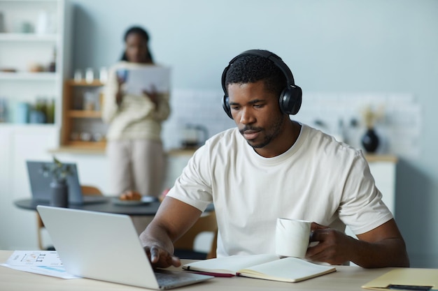 Man working online on laptop at home