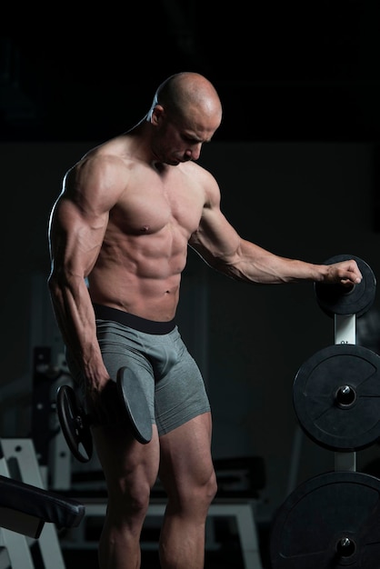 Man Working Out Biceps In A Gym  Dumbbell Concentration Curls