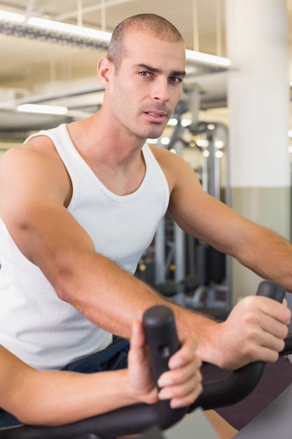 Man working out on exercise bike at gym