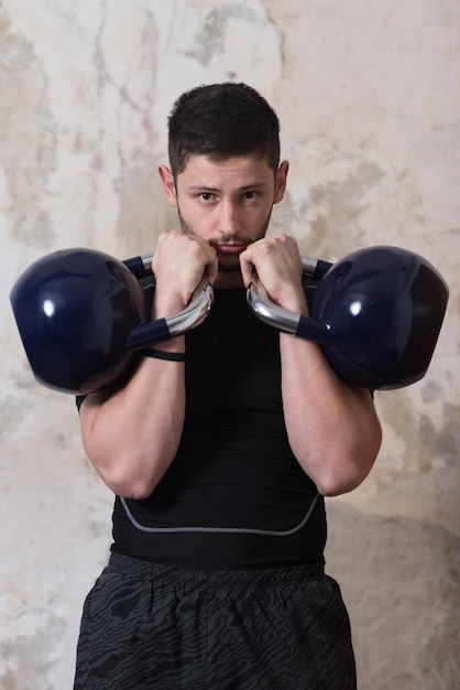 Man Working Out With Kettle Bell  Bodybuilder Doing Heavy Weight Exercise With Kettlebell