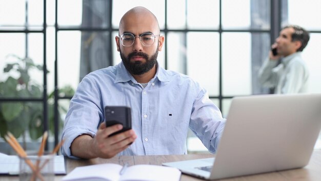 man working on the table with laptop in a new office