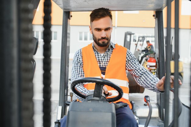 Photo man working at warehouse and driving forklift