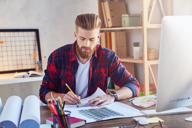 Man working with a blueprint for a new project