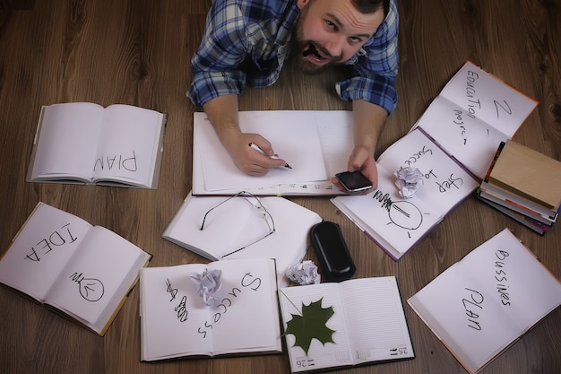 Man working with book on the floor education and bussines concept