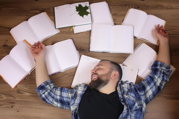 Man working with book on the floor education and bussines concept