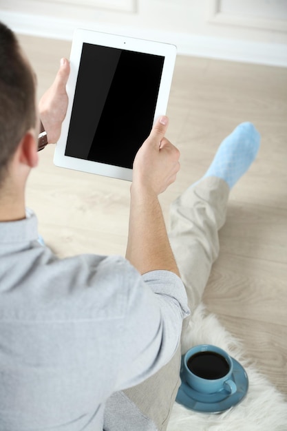 Man working with digital tablet at home