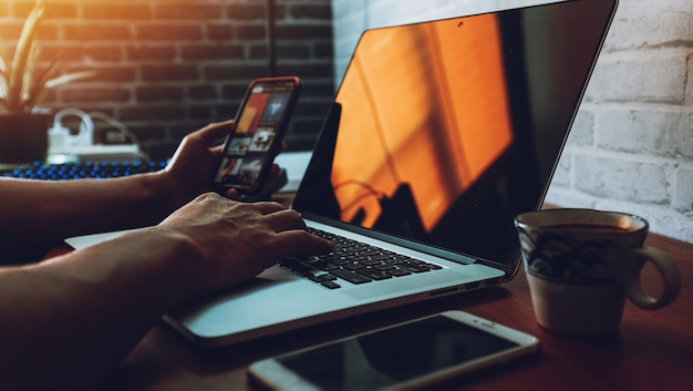 Man working with laptop keyboard and digital.