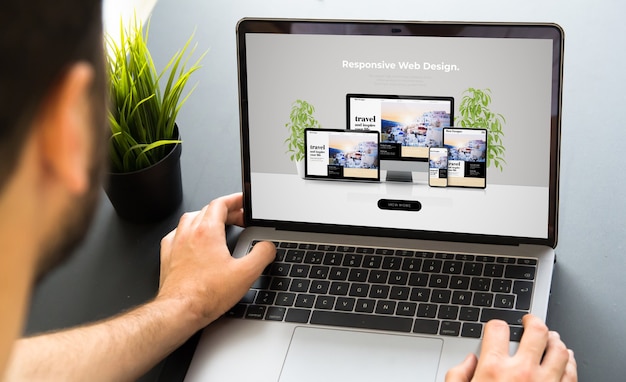 Man working with responsive website design screen laptop mock-up