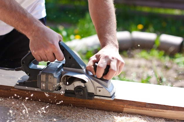 Man working with tools and wooden boards