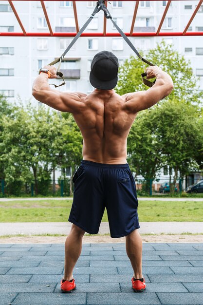 Man during workout with suspension straps