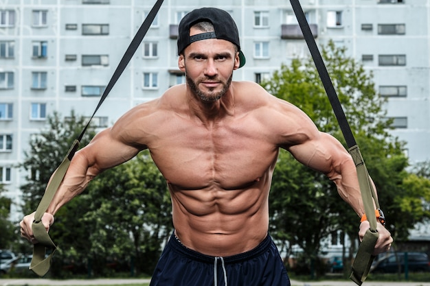 Man during workout with suspension straps