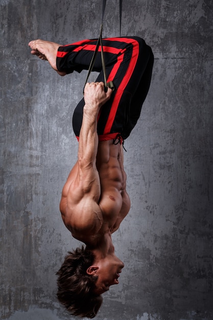 Man during workout with suspension straps