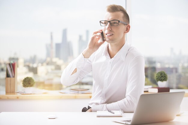 Man at workplace talking on phone