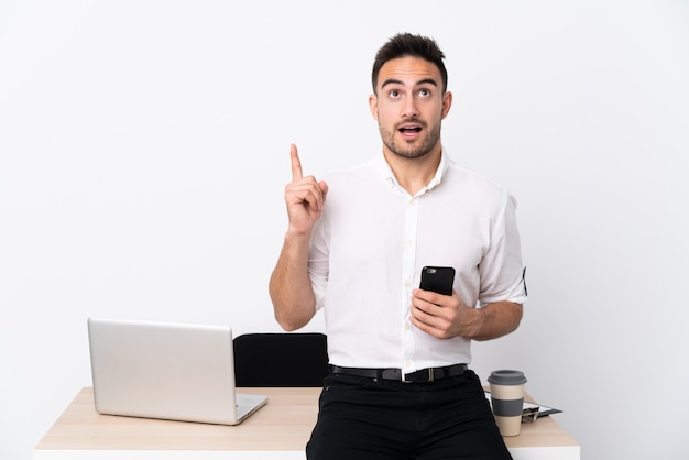 man in a workplace with a laptop