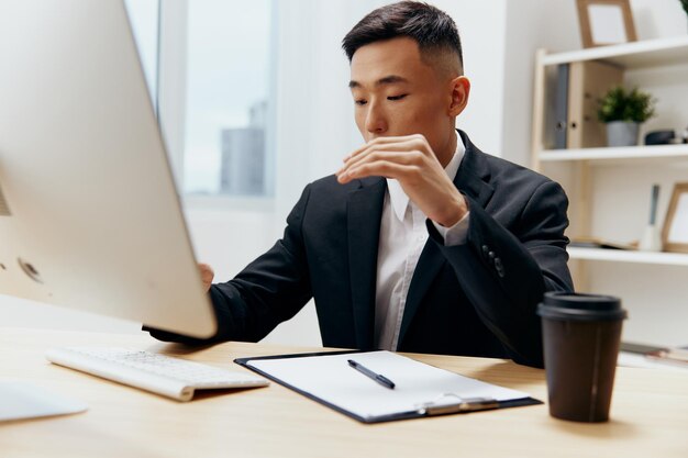 Man works at the computer glass of coffee emotion office\
technologies