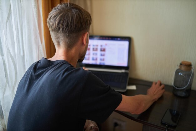 A man works at a laptop The man works at home Notebook